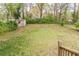 Grassy backyard with shed and mature trees, offering a serene outdoor space at 2460 Constance St, East Point, GA 30344