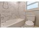 Bathroom featuring a tiled shower/tub and tile flooring at 2460 Constance St, East Point, GA 30344