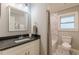 Bathroom with modern fixtures, granite counters, and patterned tile flooring at 2460 Constance St, East Point, GA 30344