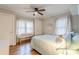 Cozy bedroom features hardwood floors, a ceiling fan, and natural light from the window at 2460 Constance St, East Point, GA 30344