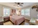 Bedroom featuring a ceiling fan, hardwood floors, natural light, and stylish decor at 2460 Constance St, East Point, GA 30344