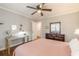 Bedroom features hardwood floors, crown molding, and a ceiling fan at 2460 Constance St, East Point, GA 30344