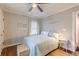 A comfortable bedroom with hardwood floors, modern decor, and a large window at 2460 Constance St, East Point, GA 30344