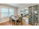 Inviting dining room features hardwood floors, a view of the living room, and natural light from the window at 2460 Constance St, East Point, GA 30344