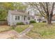 Inviting one-story home with a lush front lawn and cozy, well-maintained landscaping at 2460 Constance St, East Point, GA 30344
