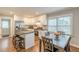 Modern kitchen boasts stainless steel appliances, a center island with seating, and an adjacent dining area at 2460 Constance St, East Point, GA 30344