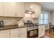Well-lit kitchen features granite countertops, white cabinets, a modern oven, and stainless-steel appliances at 2460 Constance St, East Point, GA 30344