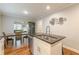Bright open concept kitchen with island and view of dining room, offering modern style with stainless steel appliances at 2460 Constance St, East Point, GA 30344