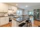 Bright open kitchen design with stainless steel appliances, island seating, and view to the living room area at 2460 Constance St, East Point, GA 30344
