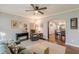 Open-concept living room with hardwood floors, neutral paint, and cozy furnishings at 2460 Constance St, East Point, GA 30344