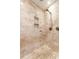 This shower includes travertine tile and a storage cubby at 2626 Peachtree Nw Rd # 412, Atlanta, GA 30305