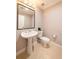 Powder room featuring a pedestal sink, a black framed mirror, and neutral walls and tile at 2626 Peachtree Nw Rd # 412, Atlanta, GA 30305