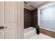 This bathroom showcases a soaking tub with brown accent wall and a closet featuring built-in shelving at 2626 Peachtree Nw Rd # 412, Atlanta, GA 30305
