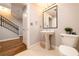Powder room with pedestal sink and next to stairway at 2626 Peachtree Nw Rd # 412, Atlanta, GA 30305