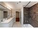 Large bathroom featuring double sinks, decorative tiles, and a shower at 2626 Peachtree Nw Rd # 412, Atlanta, GA 30305