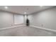 This bedroom features neutral walls, plush gray carpeting, recessed lighting, and a large window with horizontal blinds at 2626 Peachtree Nw Rd # 412, Atlanta, GA 30305