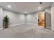 This bedroom showcases plush carpeting, neutral walls, recessed lighting, and a view into the staircase at 2626 Peachtree Nw Rd # 412, Atlanta, GA 30305