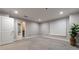 The bedroom showcases plush carpeting, neutral walls, recessed lighting, and a view into the attached bathroom at 2626 Peachtree Nw Rd # 412, Atlanta, GA 30305