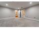 A neutral bedroom features plush carpeting, and provides access to the bathroom and staircase at 2626 Peachtree Nw Rd # 412, Atlanta, GA 30305