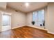 Bedroom featuring hardwood floors and a window with blinds, showcasing a doorway to the bathroom at 2626 Peachtree Nw Rd # 412, Atlanta, GA 30305