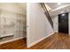 Hallway with wood floors, metal railing, and closet featuring built-in shelving for accessible storage at 2626 Peachtree Nw Rd # 412, Atlanta, GA 30305