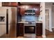 Kitchen featuring stainless steel appliances, wooden floors, granite counters, and dark wood cabinets at 2626 Peachtree Nw Rd # 412, Atlanta, GA 30305