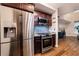 Kitchen featuring stainless steel appliances, wooden floors, granite counters, and dark wood cabinets at 2626 Peachtree Nw Rd # 412, Atlanta, GA 30305