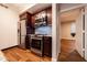 Kitchen featuring stainless steel appliances, wooden floors, granite counters, and dark wood cabinets at 2626 Peachtree Nw Rd # 412, Atlanta, GA 30305