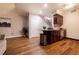 Open kitchenette area featuring dark wood cabinets, granite counters, stainless appliances, and wooden floors at 2626 Peachtree Nw Rd # 412, Atlanta, GA 30305