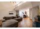 Comfortable living room with hardwood floors, gray sectional sofa, and stairs leading up at 2626 Peachtree Nw Rd # 412, Atlanta, GA 30305