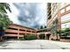 A brick parking garage next to a high-rise is framed by lush greenery at 2626 Peachtree Nw Rd # 412, Atlanta, GA 30305