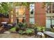 Comfortable patio seating area with grill, lush landscaping, and building view at 2626 Peachtree Nw Rd # 412, Atlanta, GA 30305