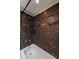 Close-up of a bathtub and shower area with striking tiled walls at 2626 Peachtree Nw Rd # 412, Atlanta, GA 30305