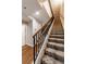 Carpeted staircase featuring wood and metal handrails leads to the upper level at 2626 Peachtree Nw Rd # 412, Atlanta, GA 30305