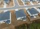 Aerial view of a neighborhood showcasing well-maintained homes, sidewalks, and landscaping at 4171 Dean Grove Way, Loganville, GA 30052
