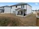 View of the backyard with a small patio and well-maintained lawn surrounded by neighboring houses at 4171 Dean Grove Way, Loganville, GA 30052