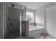 Bathroom featuring a glass shower, tub, and bright lighting at 4171 Dean Grove Way, Loganville, GA 30052