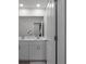Bathroom featuring a double vanity with framed mirror and modern faucets, illuminated by recessed lighting at 4171 Dean Grove Way, Loganville, GA 30052