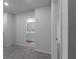 A glimpse of the en-suite bathroom as seen from the doorway of a carpeted bedroom at 4171 Dean Grove Way, Loganville, GA 30052