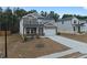 Two-story home featuring a stone and siding facade, a two-car garage, and a neatly landscaped front yard at 4171 Dean Grove Way, Loganville, GA 30052