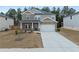 Charming two-story home with stone accents, an attached garage, and a long driveway with neat landscaping at 4171 Dean Grove Way, Loganville, GA 30052