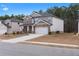 Beautiful two-story home with stone accents, a well-manicured lawn, and an attached two-car garage at 4171 Dean Grove Way, Loganville, GA 30052