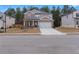 Attractive two-story home with a stone and siding exterior, a two-car garage, and a welcoming front porch at 4171 Dean Grove Way, Loganville, GA 30052