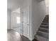 Inviting foyer area with hardwood flooring, a carpeted staircase, and natural light at 4171 Dean Grove Way, Loganville, GA 30052