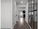 Hallway featuring hardwood floors, large mirror, and access to other rooms at 4171 Dean Grove Way, Loganville, GA 30052