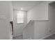 Upstairs hallway with a view of the natural lighting and neutral carpeting on the stairs at 4171 Dean Grove Way, Loganville, GA 30052