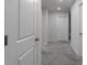 Hallway with carpet flooring leading to rooms, featuring paneled doors and recessed lighting at 4171 Dean Grove Way, Loganville, GA 30052