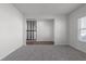 Bright living room featuring plush carpet, and large windows at 4171 Dean Grove Way, Loganville, GA 30052
