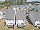 An aerial view of a community featuring modern townhomes with private back patios and well-maintained landscaping at 1433 Halpern Ln, Kennesaw, GA 30144