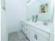 Bright bathroom featuring double sinks, white cabinetry, a modern vanity, and stylish decor at 1433 Halpern Ln, Kennesaw, GA 30144